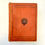 Thumbnail: Front cover of Ten Thousand Wonderful Things, rust-brown cloth with blind-stamped emblem.