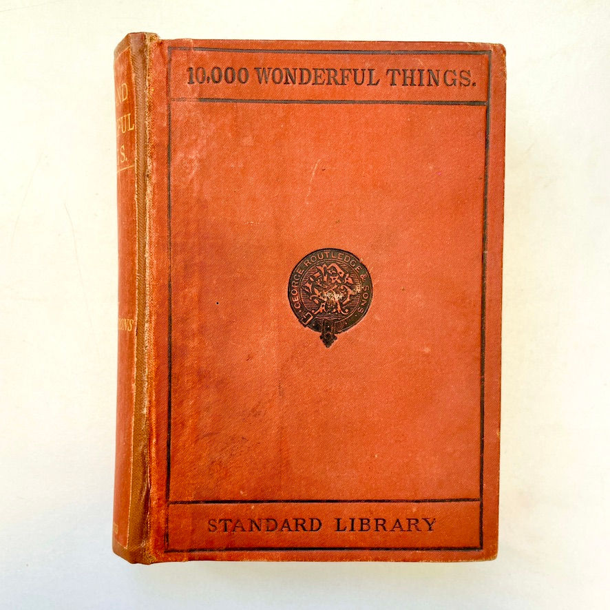 Pikkukuva: Front cover of Ten Thousand Wonderful Things, rust-brown cloth with blind-stamped emblem.