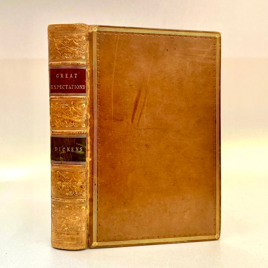 Full leather binding of the 1864 edition of Great Expectations by Charles Dickens, richly tooled spine with gilt title.