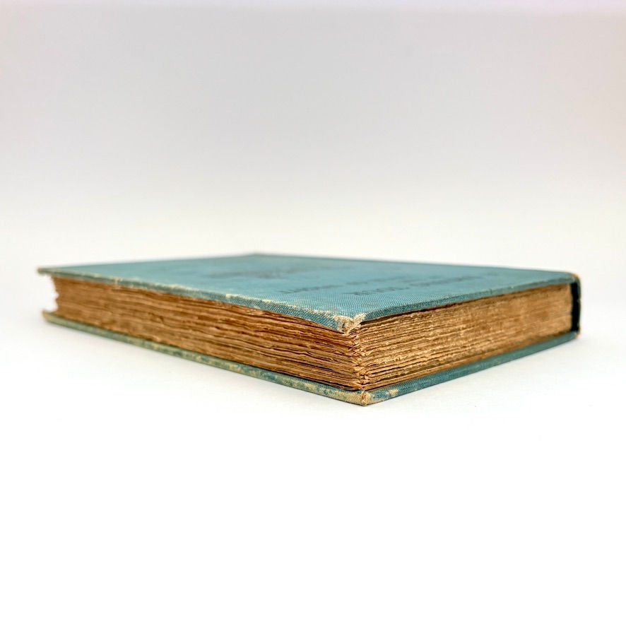 Page edge top and side of 1905 Isle of Wight travel book showing rough-cut edges and antique paper