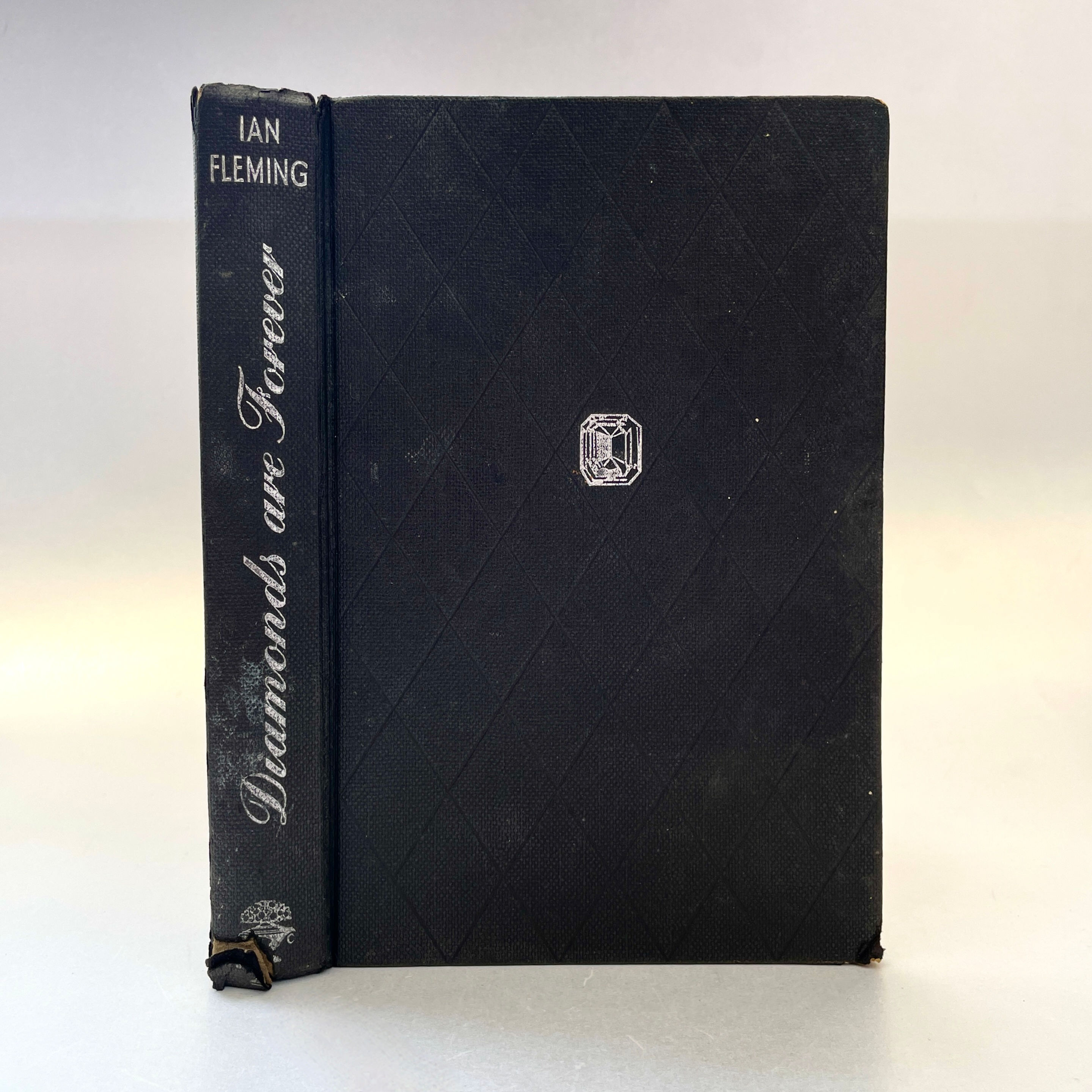 Spine and front board showing silver titles, diamond motif Diamonds Are Forever by Ian Fleming, first edition, 1956
