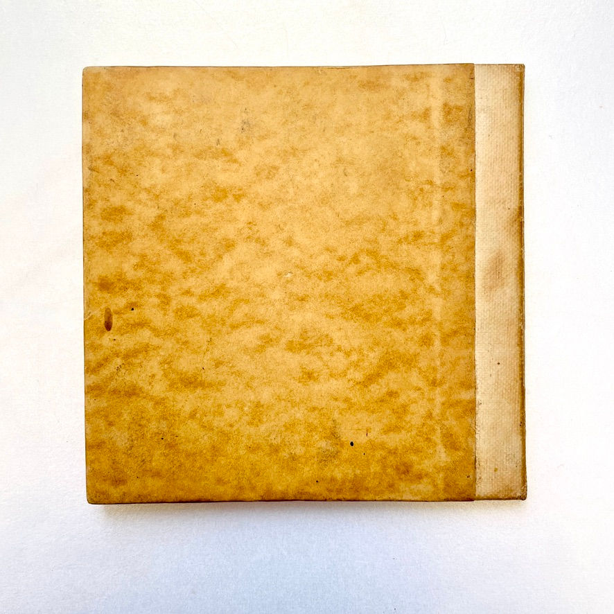 縮圖：Rear cover in paper over boards with visible age wear