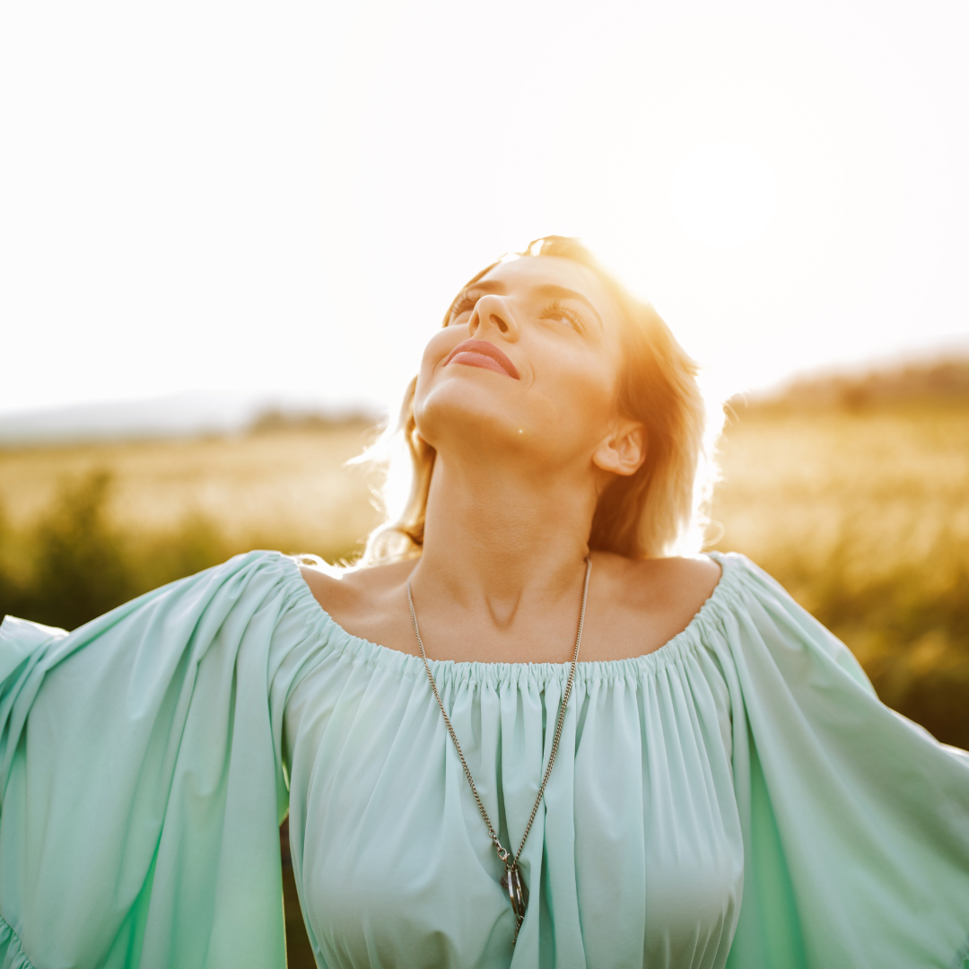 woman relaxing outdoors during hypnotherapy consultation for stress relief and inner healing