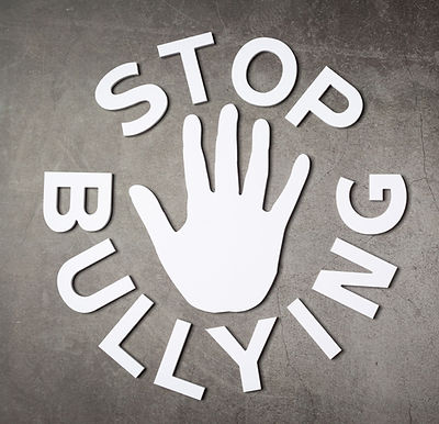 word-stop-bullying-with-hand-sign-dark-wall_edited.jpg