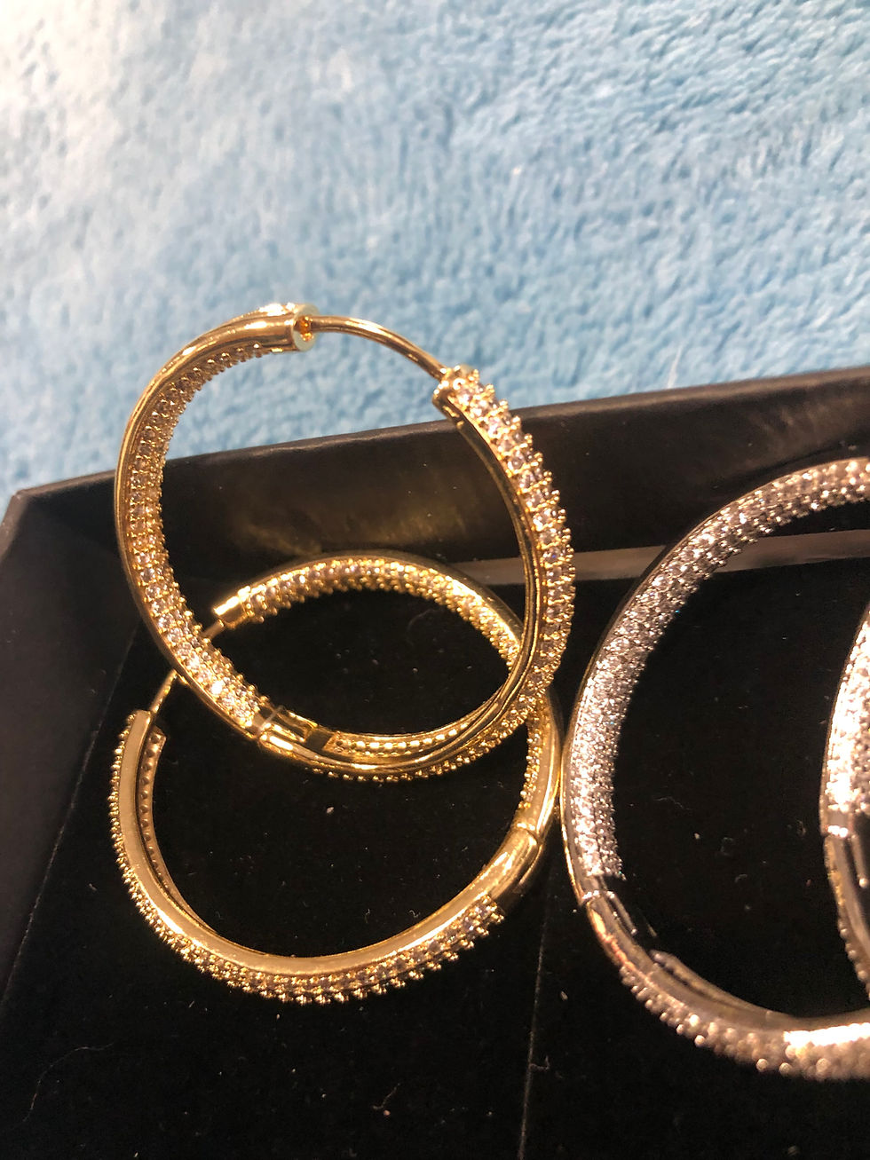 Thumbnail: Silver or gold diamond hoop earrings.