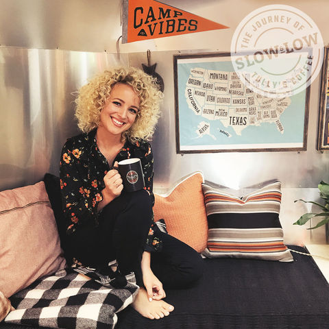 Singer and songwriter Cam enjoying Tullys coffee inside the camper.