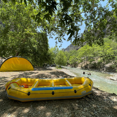 a yellow raft sitting outside the river