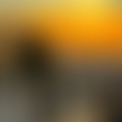 Climber on the summit of Mount Toubkal with the sunrising over the Atlas Mountains