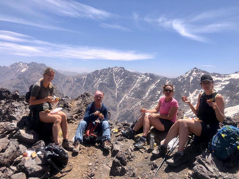 Wildaxis team sitting on mountain top