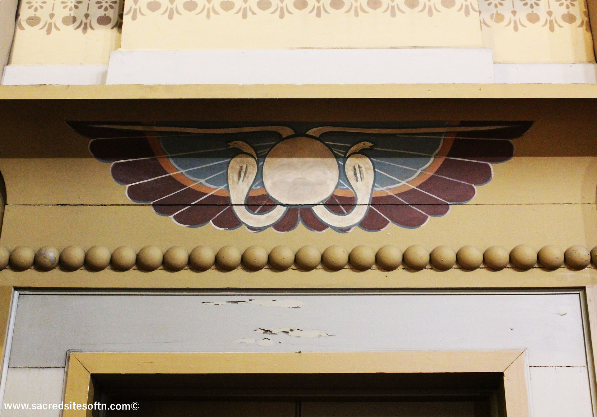 The Winged Sun symbol graces a doorway