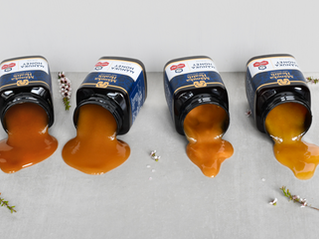 Manuka honey bottles laying down on the table