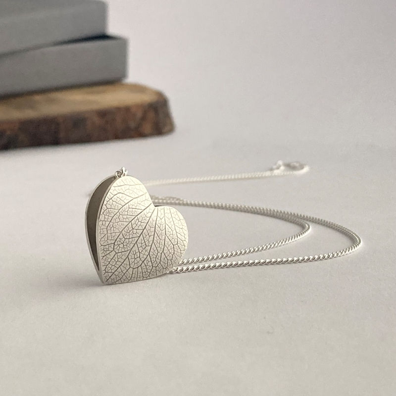 Sterling Silver Botanical Heart Pendant displayed on a white background