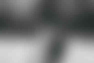 Bride and groom sitting on swing at East Mersea Hall wedding