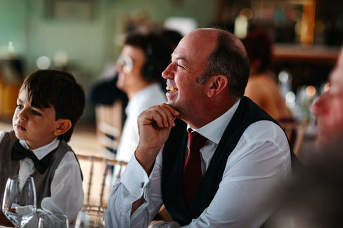 Guests laughing during speeches at High House Wedding, Maldon