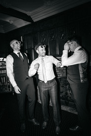 Groom and groomsmen laughing at Woodhall Manor, Woodbridge