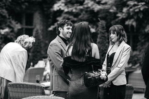 Guests talking at Seckford Hall wedding 