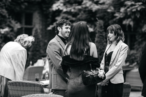 Guests talking at Seckford Hall wedding