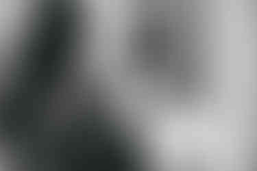 Bridesmaid putting earrings in for bride at Seckford Hall wedding