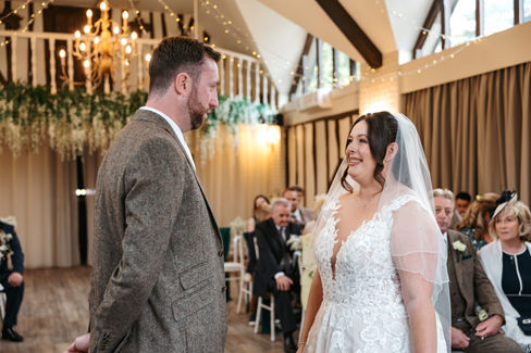 Bride and groom smiling together at Seckford Hall wedding 