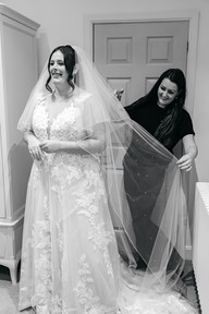 Brides veil being sprayed with perfume at Seckford Hall wedding