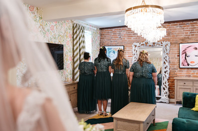 First look with bridesmaids at Seckford Hall wedding