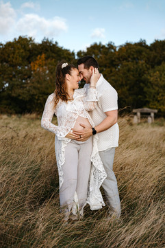 Couple holding baby bump for Essex maternity photographer