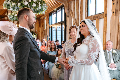 Bride placing ring on grooms finer at High House Wedding, Maldon