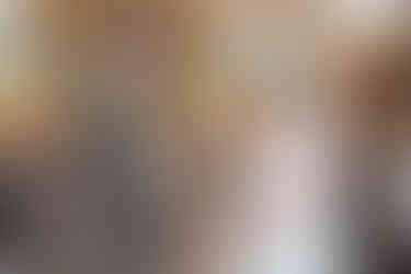 Bride placing ring on grooms finger at Seckford Hall wedding