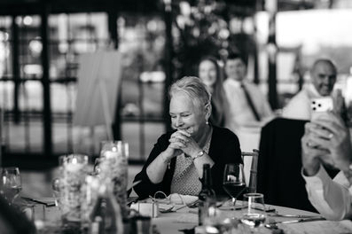 Guest laughing during speeches at High House Wedding, Maldon