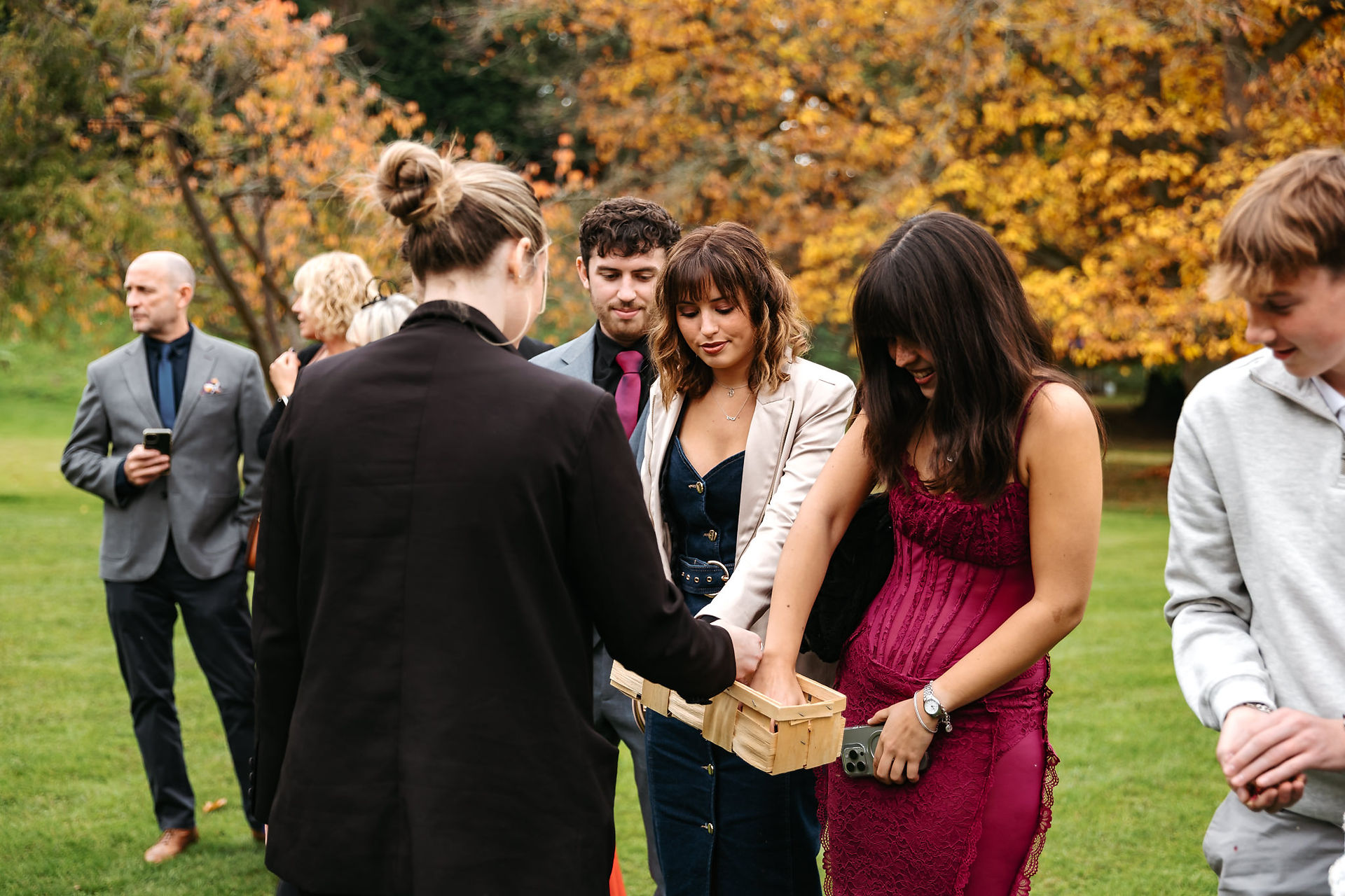 Guests grabbing confetti at Seckford Hall wedding 