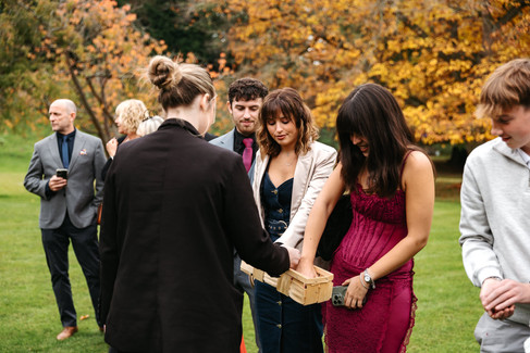 Guests grabbing confetti at Seckford Hall wedding