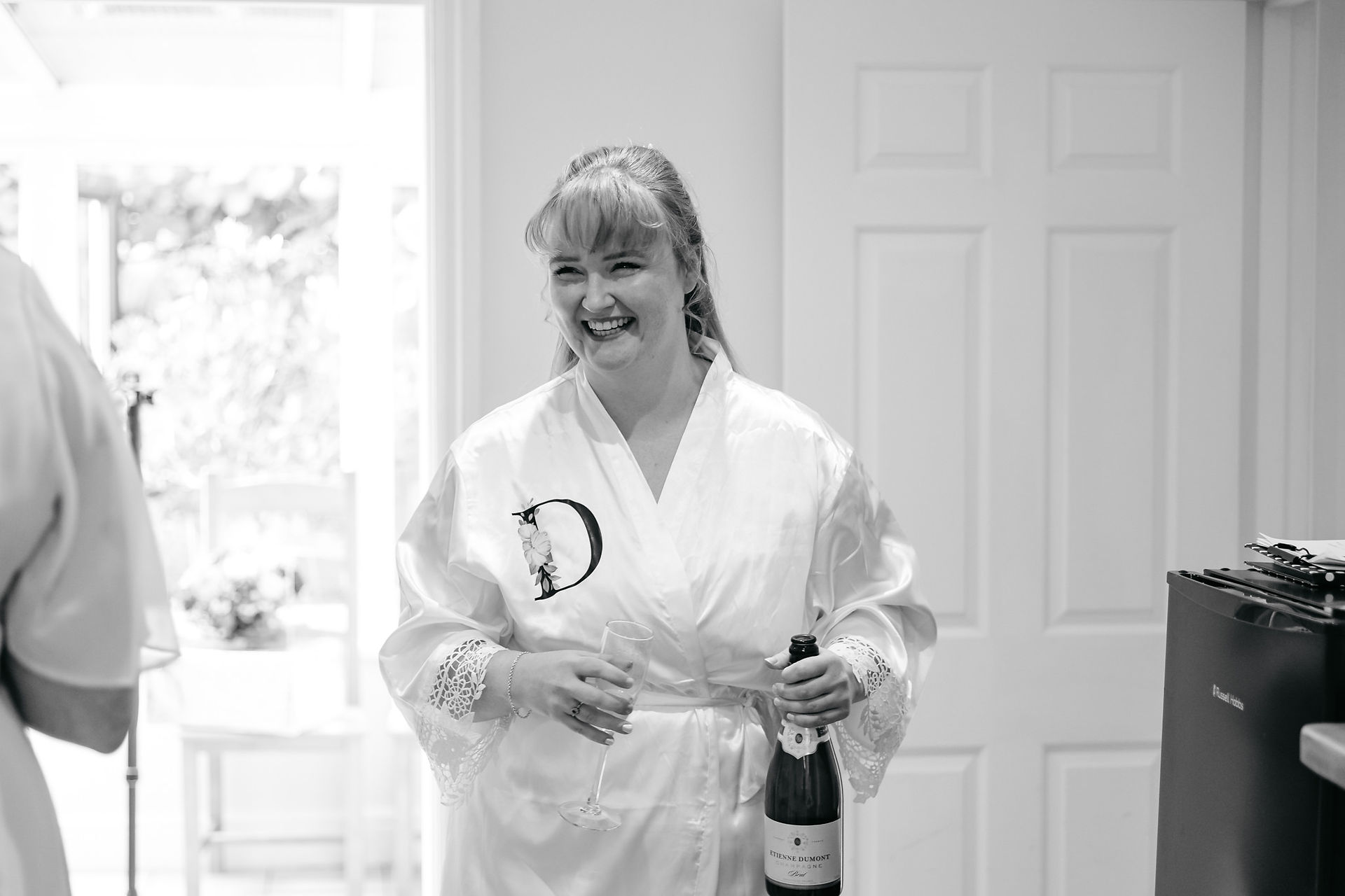Bride getting prosecco at East Mersea Hall wedding