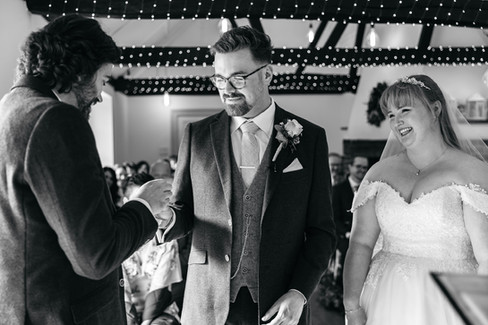 Groom taking ring at East Mersea Hall wedding
