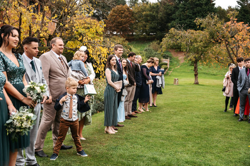 Guests lining up for confetti shot at Seckford Hall wedding