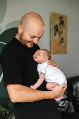 father holding baby in newborn shoot