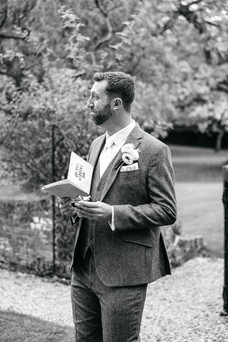 Groom crying at letter at Seckford Hall wedding