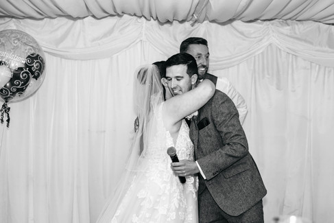 Best man hugging bride Seckford Hall wedding