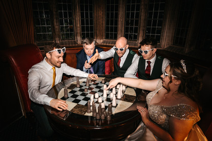 Bridal party playing chess at Woodhall Manor, Woodbridge