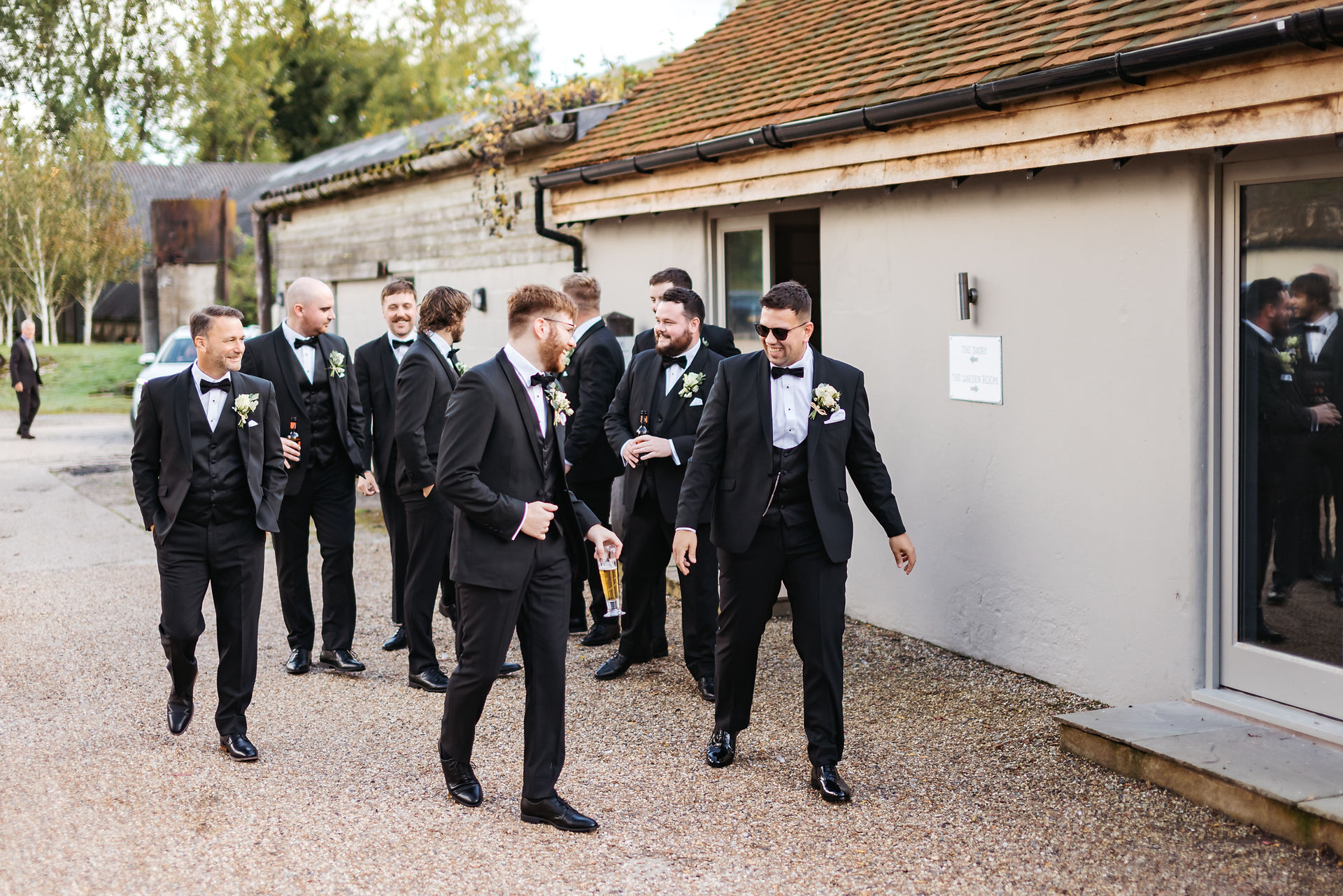 Groom and groomsmen walking at Houchins Wedding - Beth & James