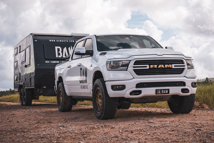RAM 1500 towing a caravan after an America's Garage GVM upgrade, legally rated to carry and tow more across Australia.