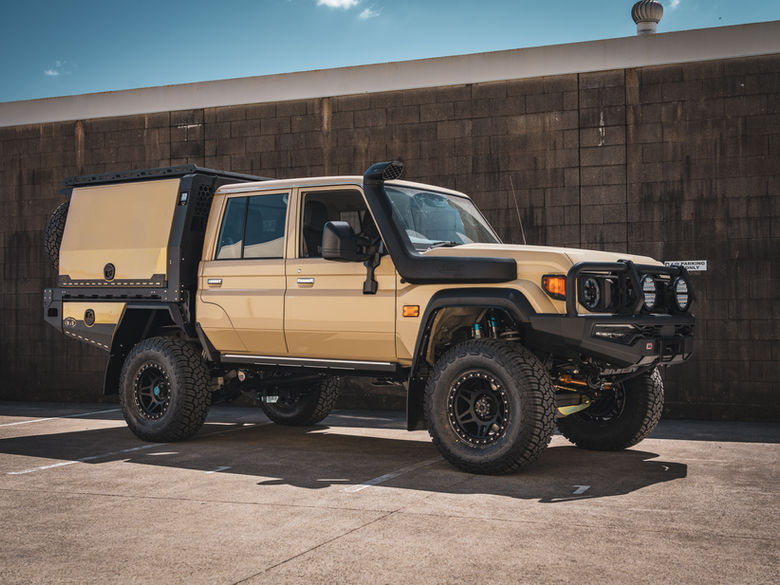 DualCab 79 Series V8 LandCruiser with canopy, lifted suspension and touring setup parked outside workshop.