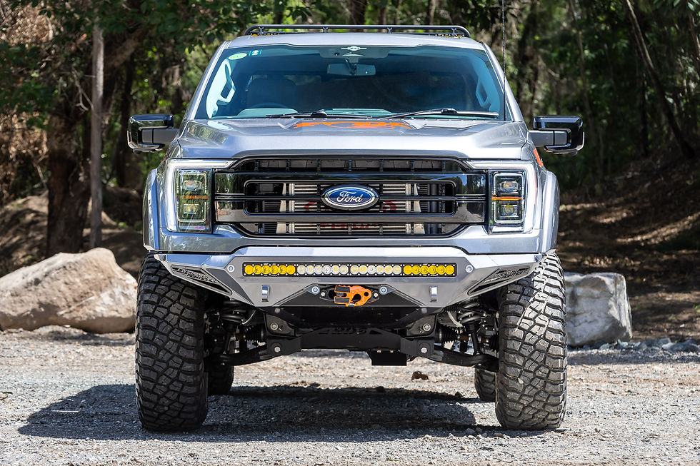 Ford F-150 with Offroad Industries Stage 5 GVM upgrade to 3700kg, 4-inch BDS lift, 35-inch tyres, bull bar and amber LED light bar, front-on shot in bush setting.