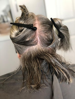 Rear view of Esther’s haircut in progress, transitioning from long hair to a short bob at her home in Atherstone.