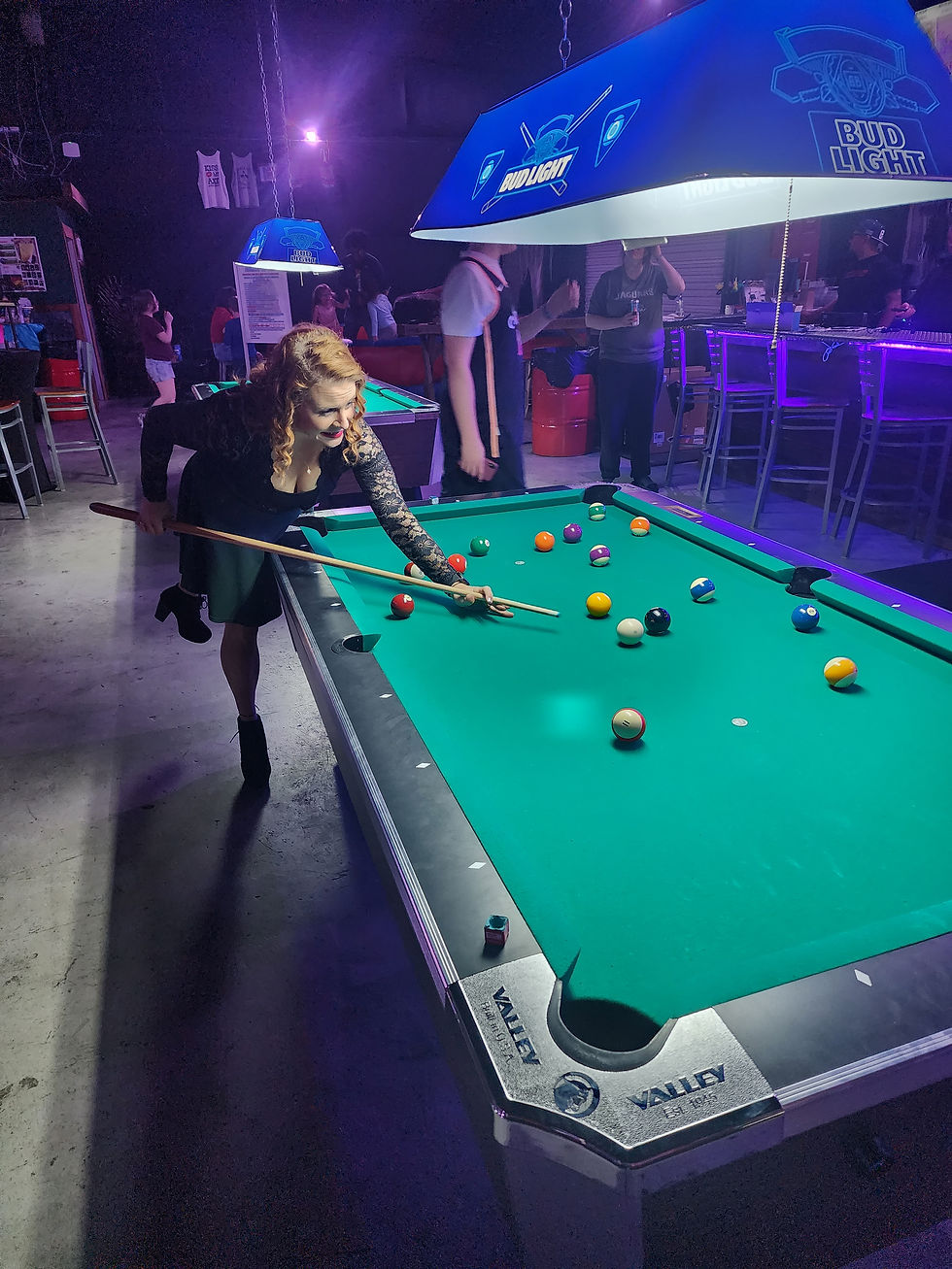 Woman playing pool at Unleashed Axe Throwing Bar & Lounge