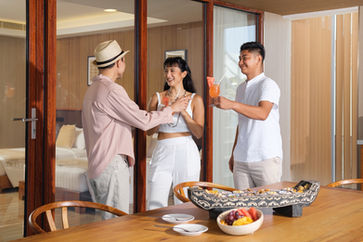 A photo of a butler serving guests welcome drinks and welcome treats at Sunlight Ecotourism Island Resort