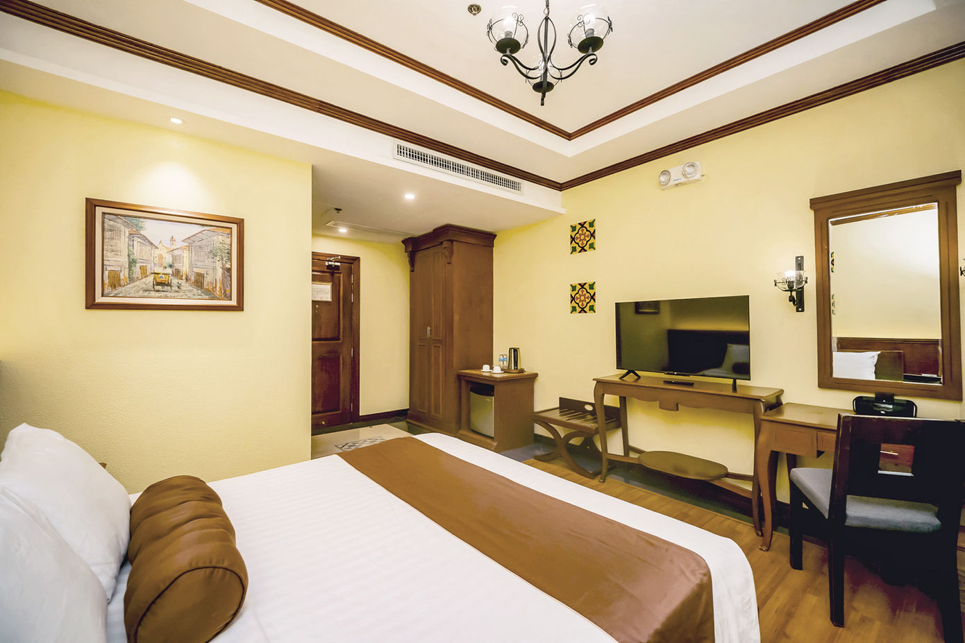 King sized bed against a wall with the Superior Room amenities around it
