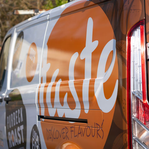Van with "Taste" logo and branding.