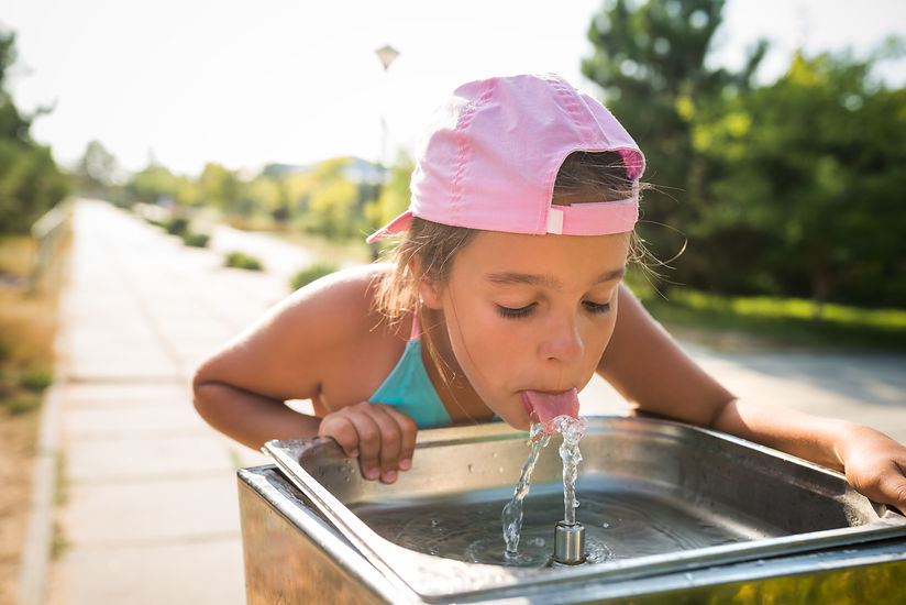 cute-thirsty-girl-drinks-water-from-drin