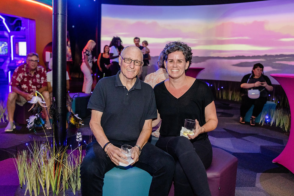 Couple enjoying drinks together inside FloridaRAMA's immersive projection room — a truly unique date spot in St. Pete.