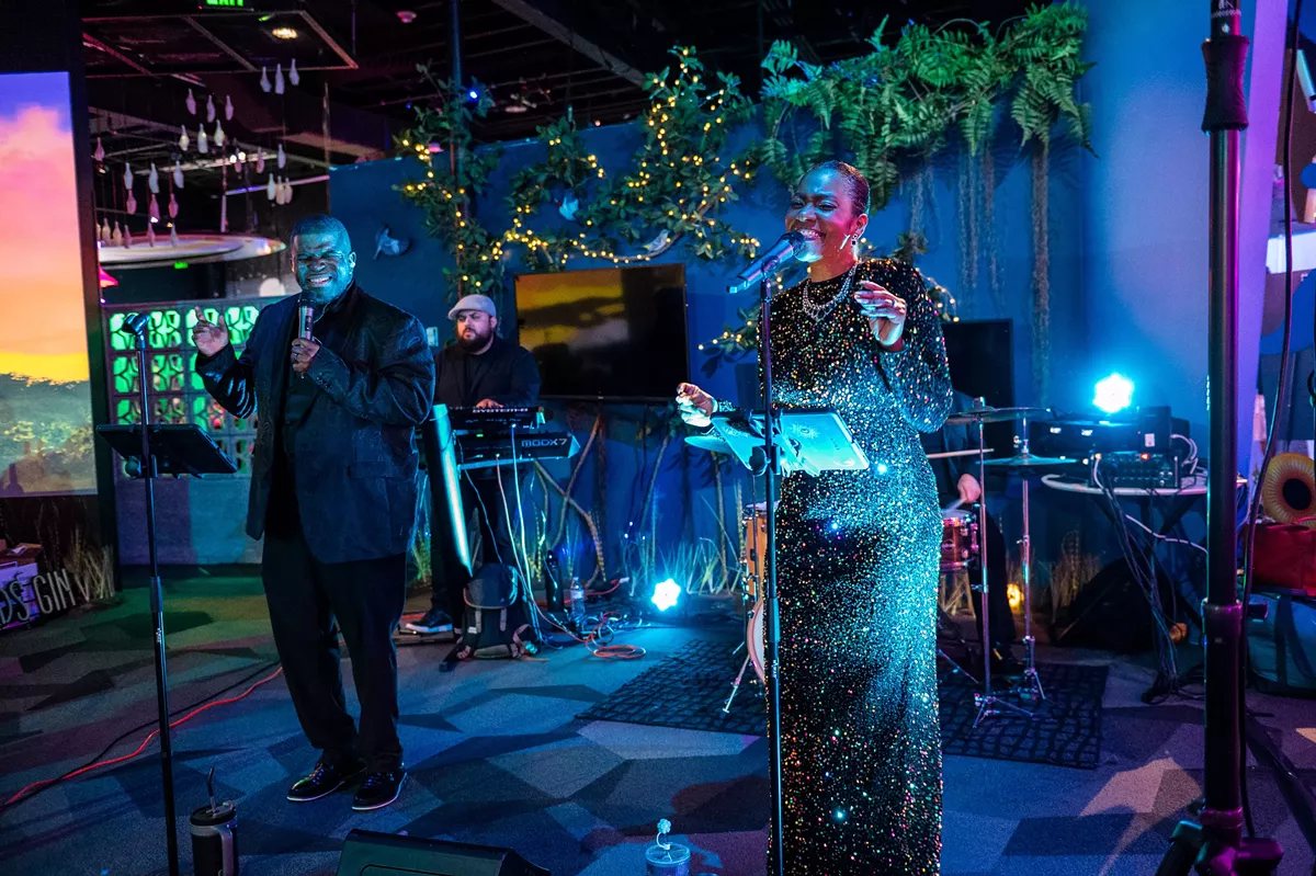 Live music duo performing on stage during a corporate holiday party at FloridaRAMA.